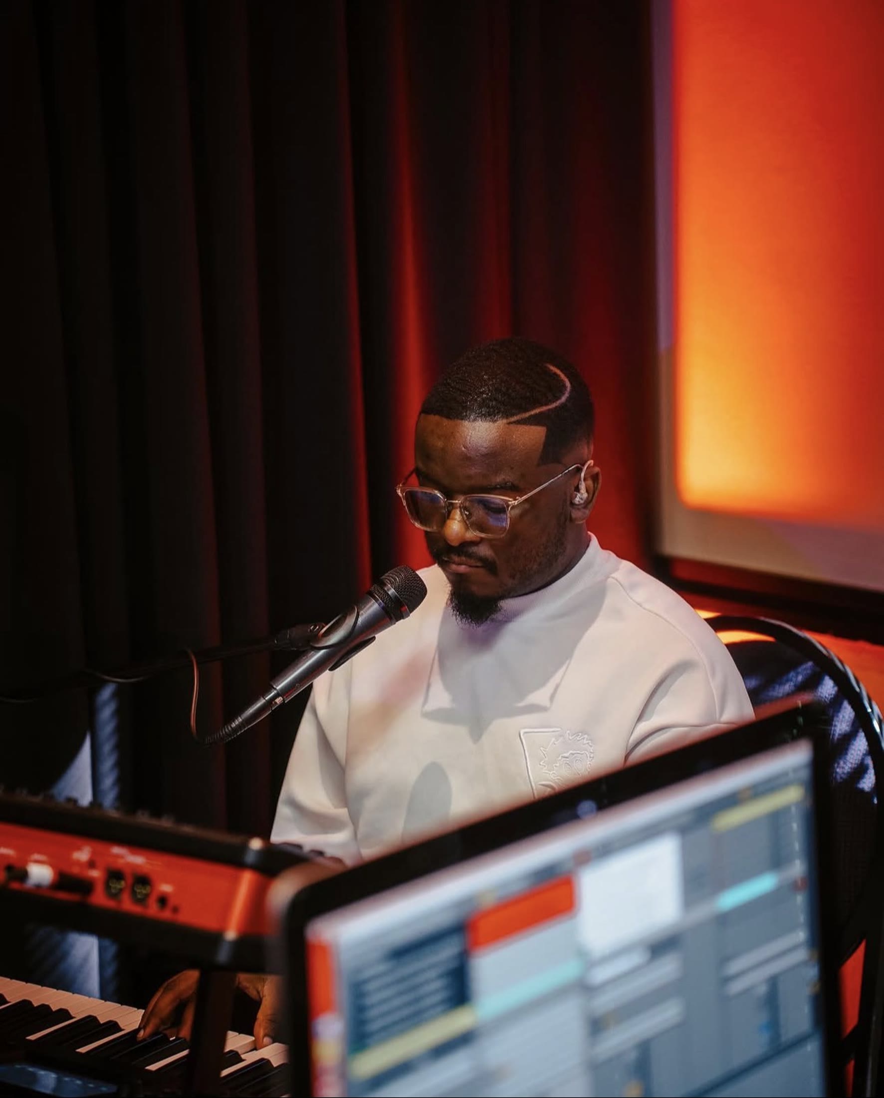 A worship musician singing while playing the keys